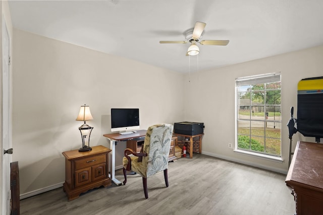 office featuring a ceiling fan, baseboards, and wood finished floors