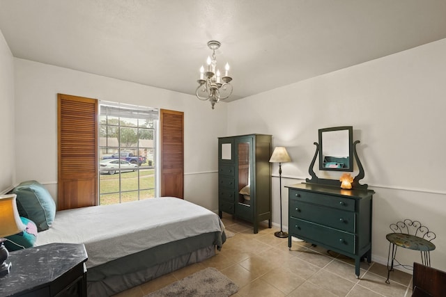 bedroom featuring baseboards, access to outside, light tile patterned flooring, and a notable chandelier