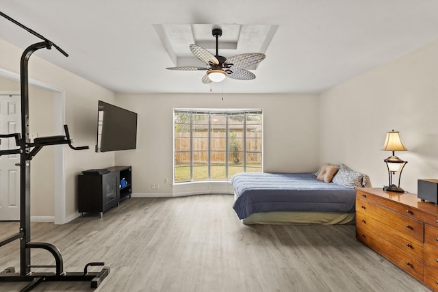 bedroom featuring baseboards and wood finished floors