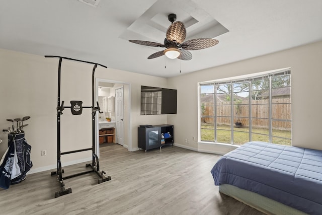 bedroom featuring a ceiling fan, connected bathroom, baseboards, and wood finished floors