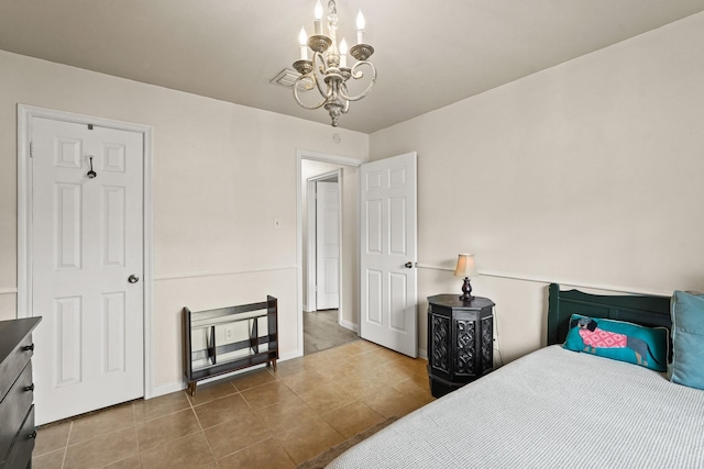 tiled bedroom with a chandelier, visible vents, and baseboards