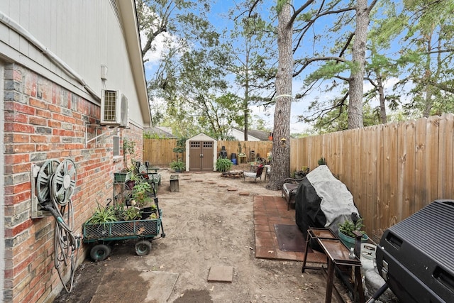 view of yard featuring an outbuilding, a fenced backyard, a garden, a shed, and ac unit