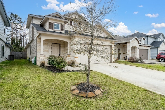 view of front of home featuring central AC unit, fence, stone siding, concrete driveway, and a front yard