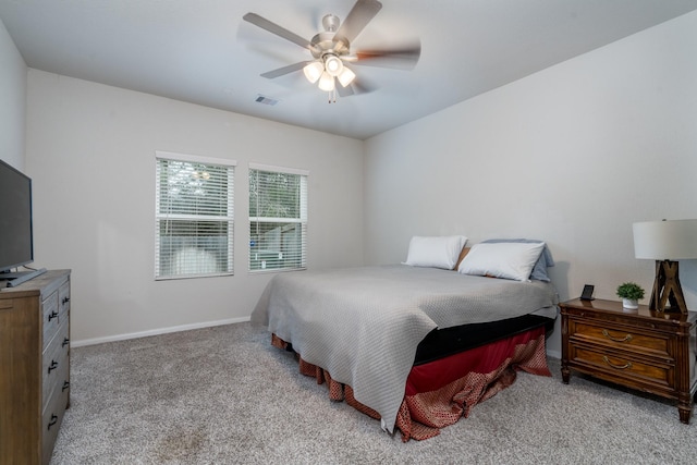 carpeted bedroom with a ceiling fan, visible vents, and baseboards