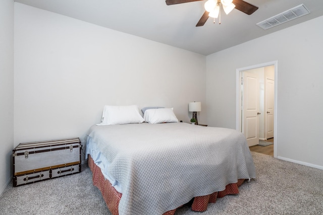 carpeted bedroom featuring visible vents, ceiling fan, and baseboards