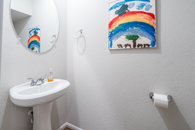 bathroom featuring a textured wall