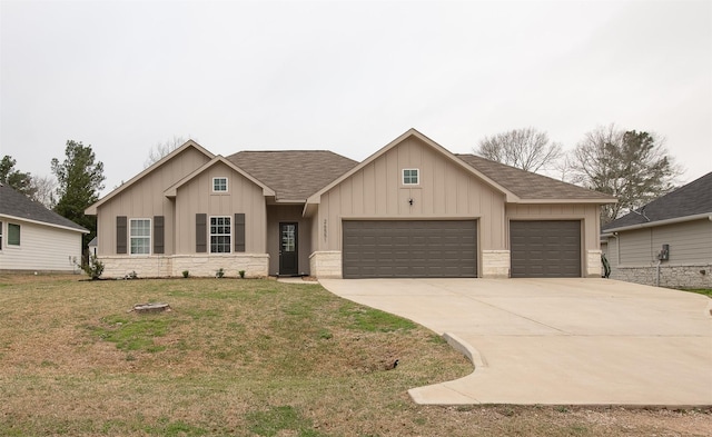 view of front of home with roof with shingles, board and batten siding, a garage, driveway, and a front lawn