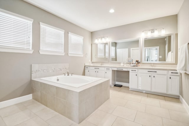 full bath featuring a bath, a sink, tile patterned floors, and double vanity