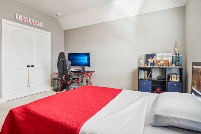 bedroom with a closet, carpet flooring, and lofted ceiling