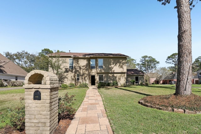 view of front of home with a front lawn and stucco siding