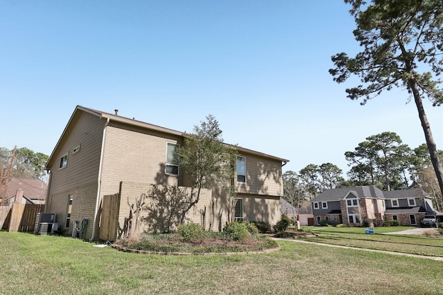 view of property exterior with a lawn, brick siding, and central AC