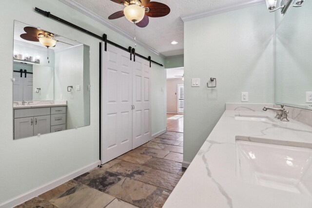 bathroom with double vanity, a ceiling fan, ornamental molding, and a sink