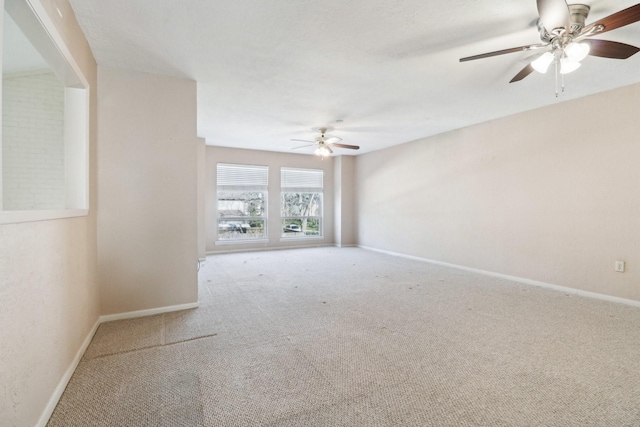 empty room featuring carpet, ceiling fan, and baseboards