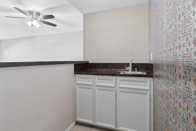 bar featuring ceiling fan and a sink
