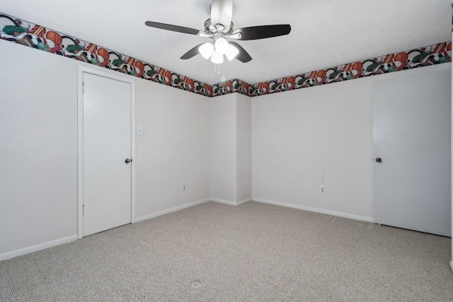 unfurnished room with ceiling fan, carpet floors, and baseboards