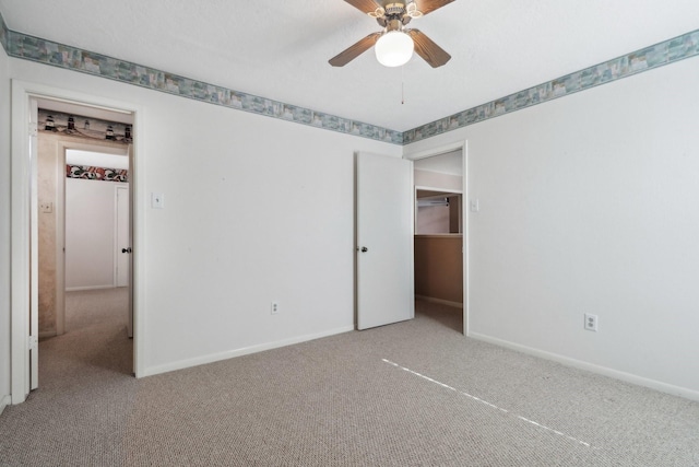 unfurnished bedroom with baseboards, carpet, and ceiling fan