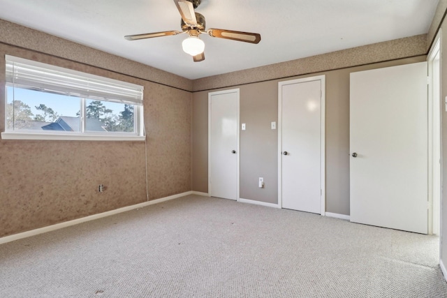 unfurnished bedroom featuring carpet floors, ceiling fan, baseboards, and a closet