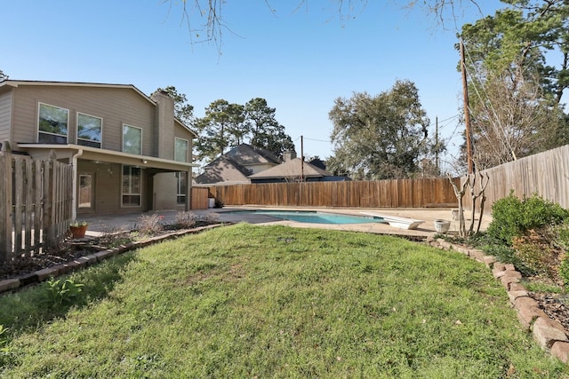 view of yard featuring a fenced backyard, a fenced in pool, and a patio