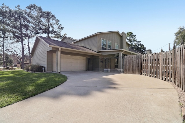 view of front of house with a front lawn, a chimney, concrete driveway, fence, and an attached garage
