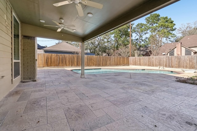 view of patio featuring a fenced backyard, a fenced in pool, and a ceiling fan