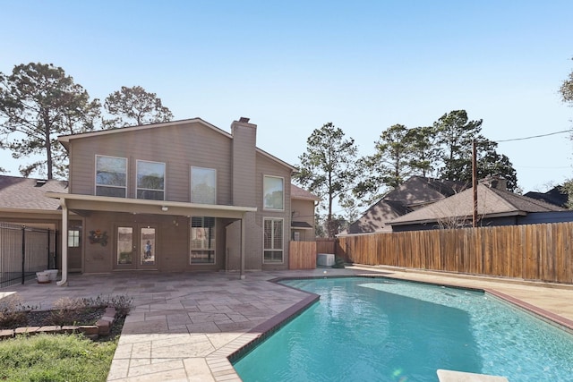 view of pool featuring a fenced in pool, french doors, a fenced backyard, central air condition unit, and a patio