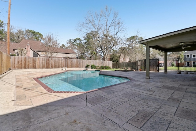 view of swimming pool with a fenced backyard, ceiling fan, a fenced in pool, and a patio