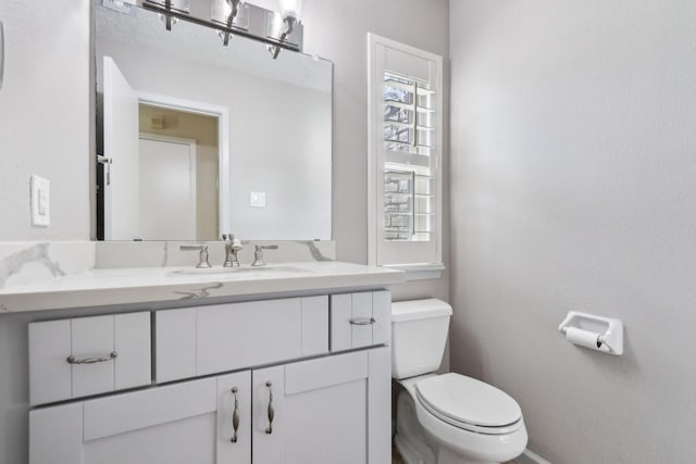 half bath with vanity and toilet