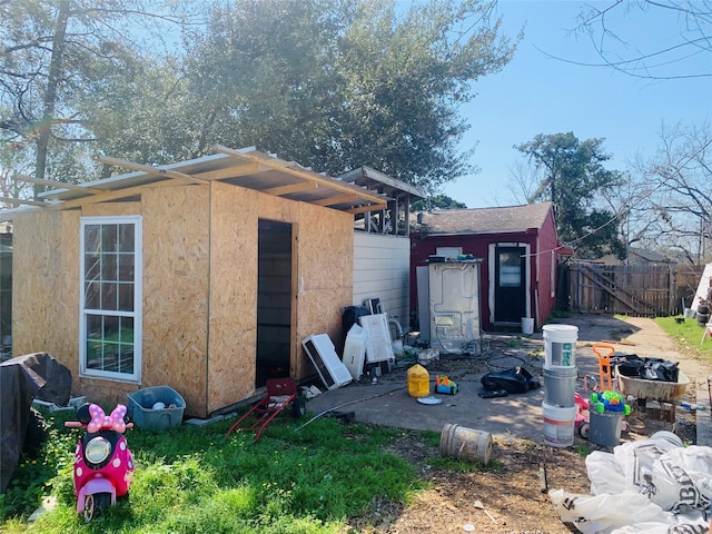 view of outbuilding with fence