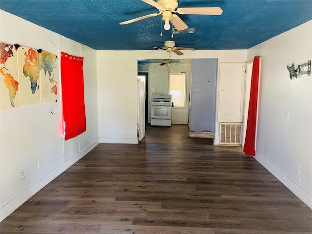 unfurnished room featuring baseboards, visible vents, ceiling fan, wood finished floors, and a textured ceiling