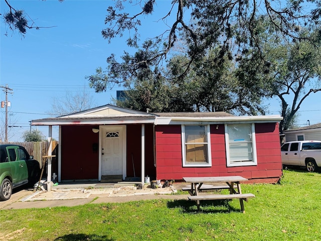 view of front of property with a front yard and fence