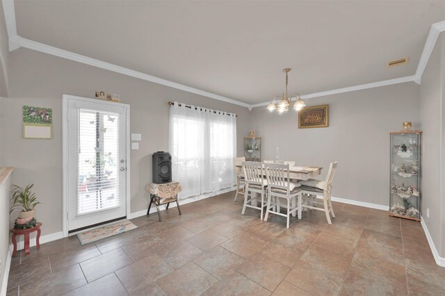 dining area with baseboards, a chandelier, and crown molding