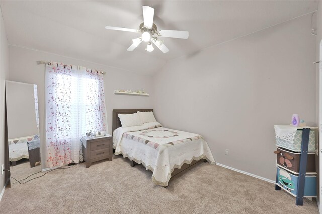 bedroom with carpet floors, lofted ceiling, ceiling fan, and baseboards