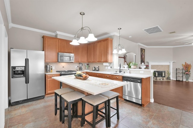 kitchen with stainless steel appliances, light countertops, a sink, and visible vents