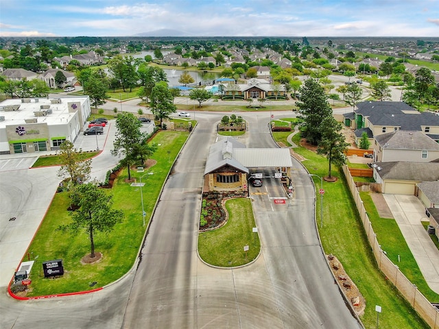 drone / aerial view featuring a residential view and a water view