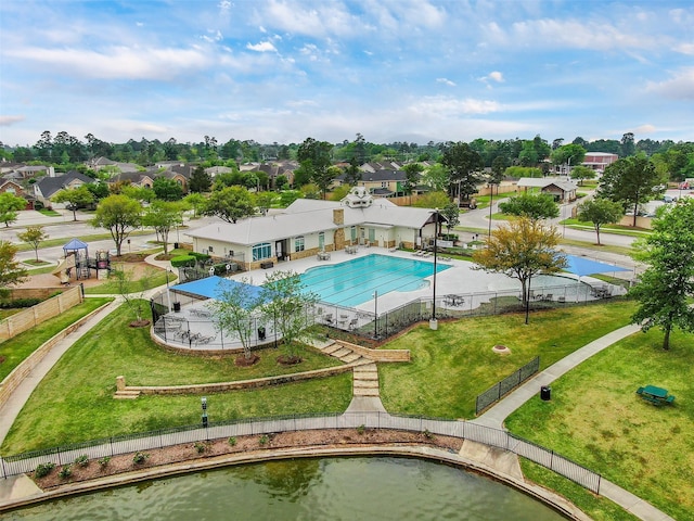 pool with a patio, a yard, fence, and a residential view