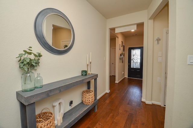 interior space featuring dark wood-type flooring and baseboards