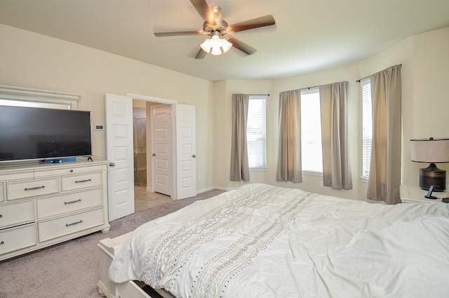 bedroom with a ceiling fan and light colored carpet