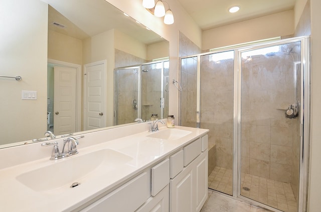 bathroom with visible vents, a sink, a shower stall, and double vanity