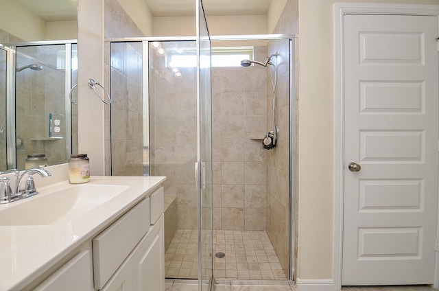 full bathroom with a stall shower and vanity