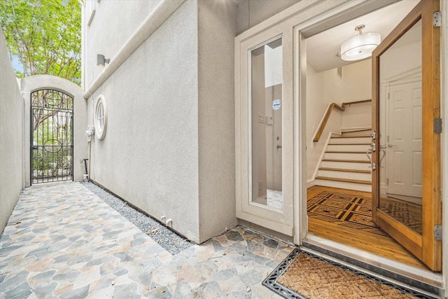 property entrance featuring stucco siding and a gate