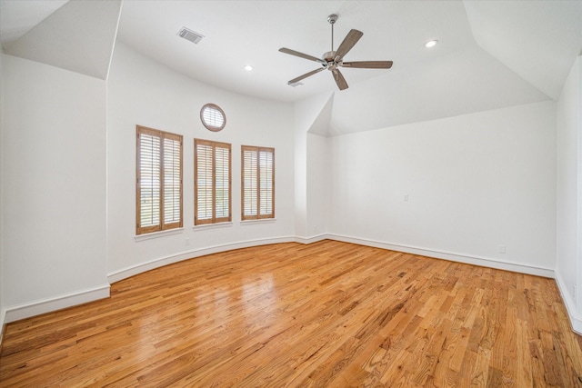 empty room featuring visible vents, wood finished floors, recessed lighting, baseboards, and vaulted ceiling