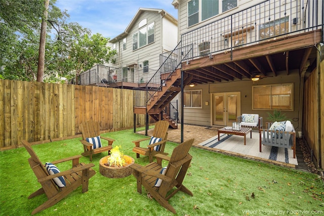 view of yard featuring fence, a wooden deck, stairs, french doors, and a patio area