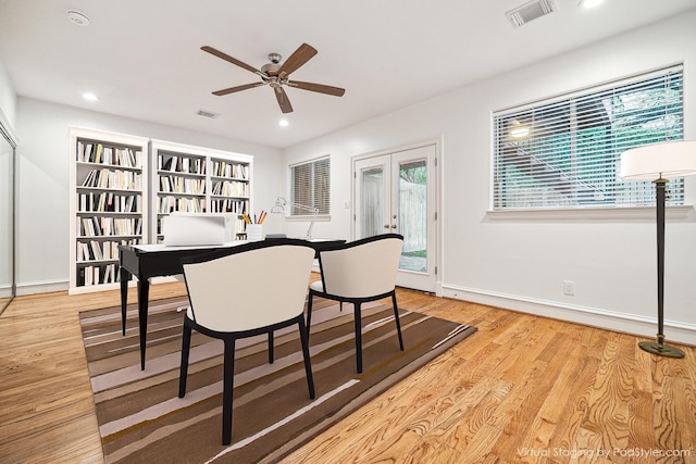 dining area featuring light wood-style flooring, french doors, and visible vents