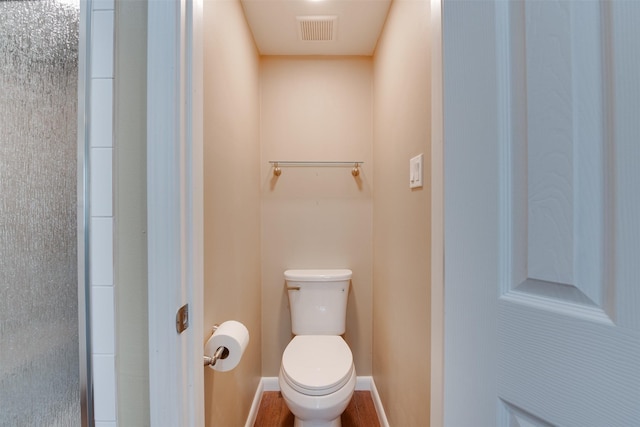 bathroom featuring baseboards, visible vents, and toilet