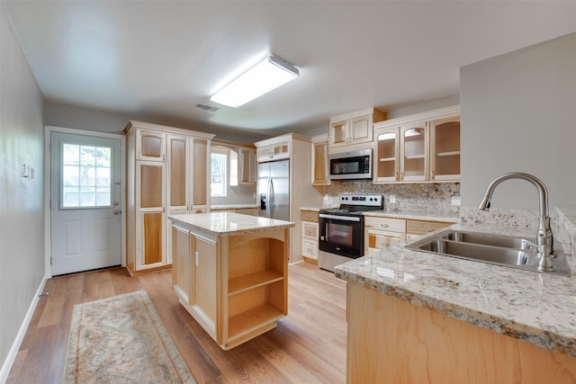 kitchen with open shelves, visible vents, light wood-style flooring, appliances with stainless steel finishes, and a sink