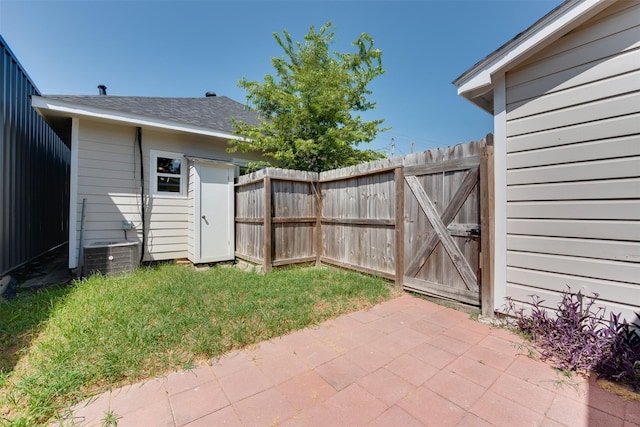 view of yard featuring a patio area, fence, and a gate