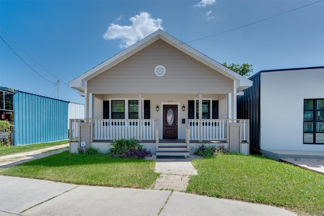 view of front of home featuring a porch and a front yard