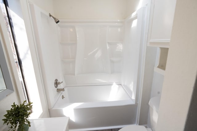 bathroom featuring toilet, tub / shower combination, and vanity