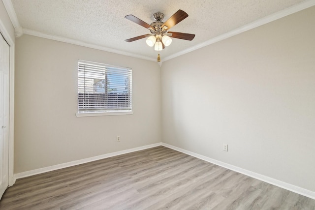 unfurnished bedroom with a textured ceiling, light wood finished floors, and crown molding