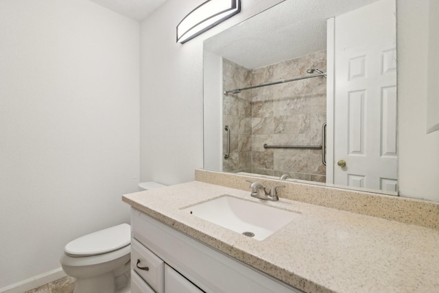 full bathroom featuring toilet, tiled shower, and vanity